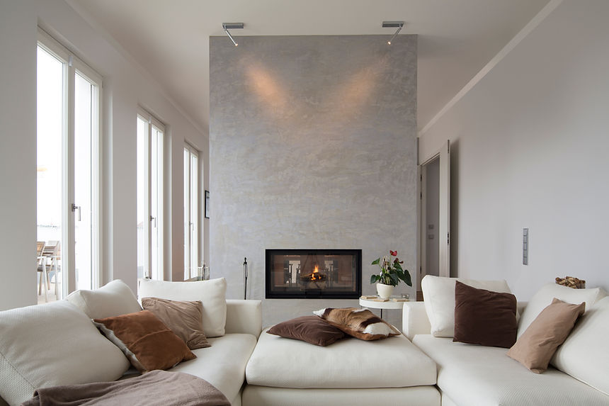 A soffa standing in front of a digital fireplace on a concrete wall