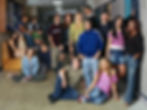 Group of students standing in a in school hallway lined with lockers