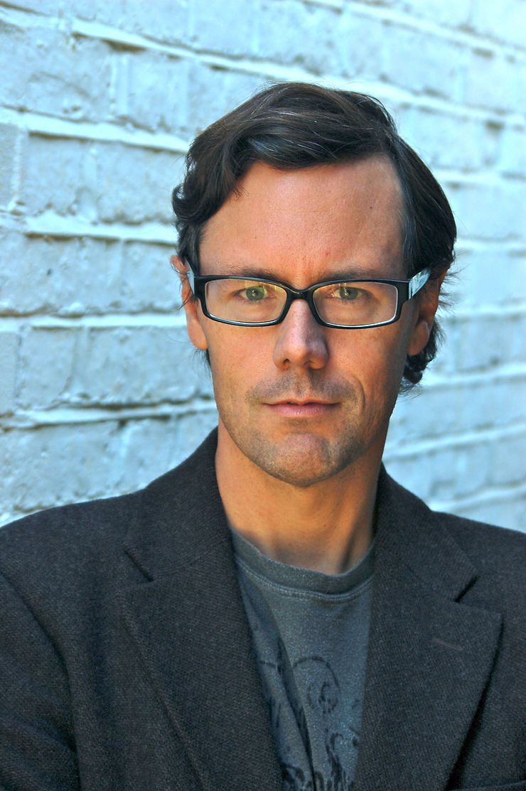 Headshot of Jeff Norton wearing a grey suit jacket