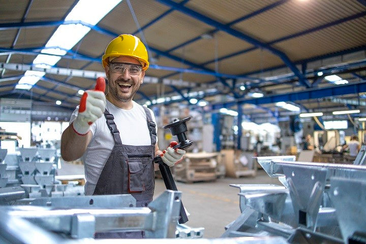portrait-factory-worker-protective-equipment-holding-thumbs-up-production-hall.jpg