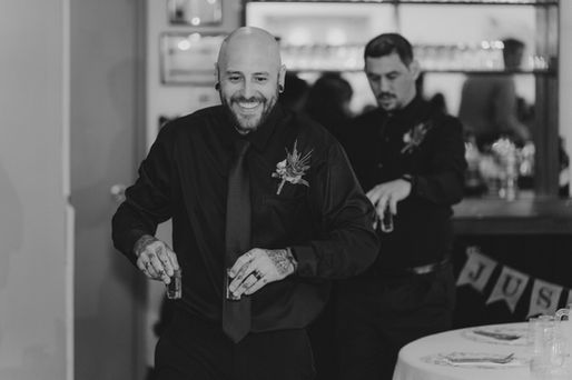 groomsmen taking a shot at a bar