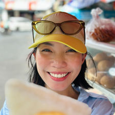 Ms. Yummyface, local Hanoi food tour host showing off Saigon street food