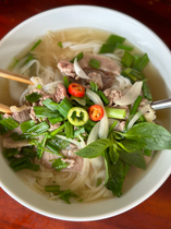 Fragrant bowl of phở bò with sliced beef, basil, spring onions, and chili — a warm and comforting way to start the day in Phu Quoc