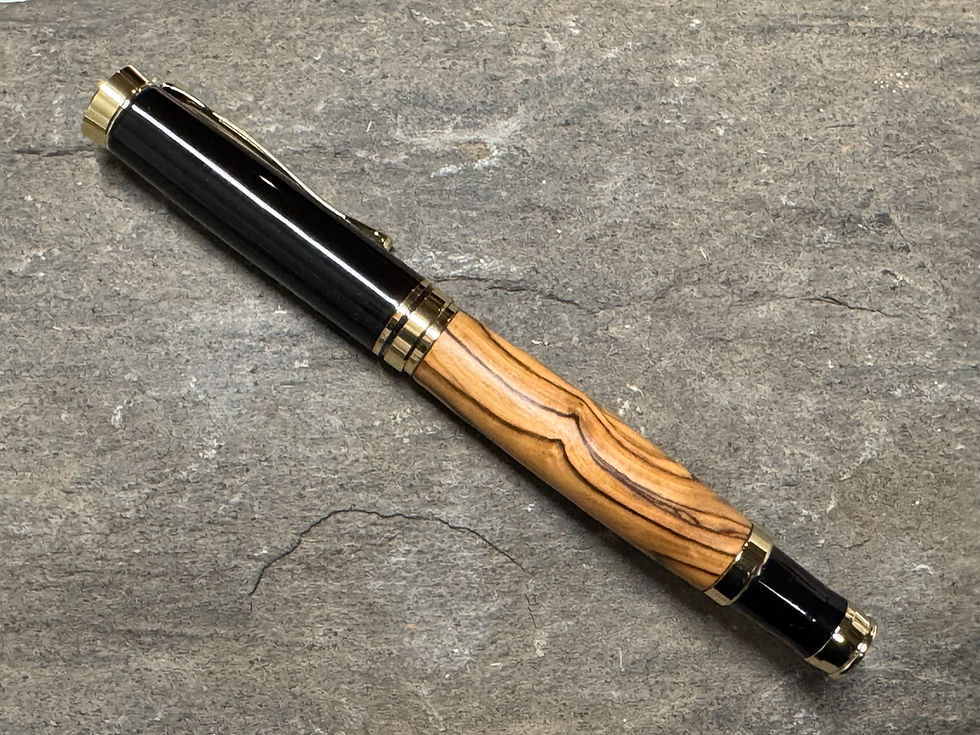 Thumbnail: Bethlehem Olive Wood on Black and Gold Rollerball