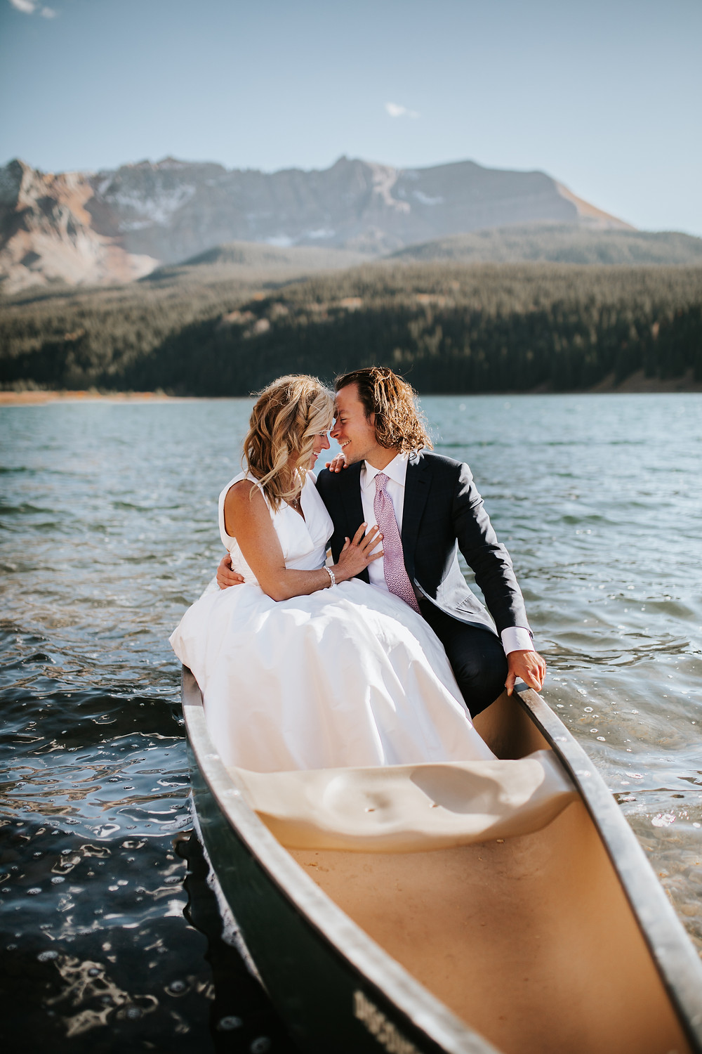 Elopement couple sitting in a canoe at Trout Lake in Telluride, Colorado