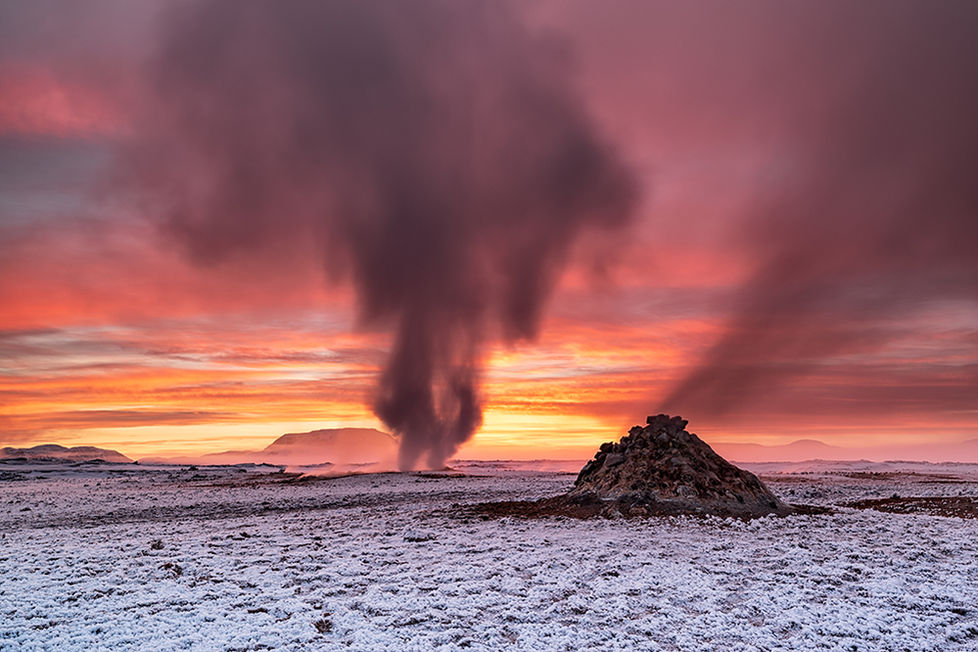Hverir is a fascinating geothermal area located near Lake Mývatn in northeastern Iceland. It is renowned for its otherworldly landscape, characterized by steaming fumaroles, bubbling mud pots, and vibrant mineral deposits. The area lies at the foot of the Námafjall mountain, which is part of the larger volcanic landscape of Iceland.
The geothermal activity at Hverir is a result of the region's unique geological setting, where the North American and Eurasian tectonic plates meet. This tectonic activity provides the heat that fuels the geothermal phenomena, making Hverir a prime example of Iceland's dynamic geological processes.
The ground is often covered in colorful mineral-rich sediments, ranging from bright yellows to deep reds and greens, resulting from the high sulfur content and other minerals in the area. The constant release of steam and gases creates an otherworldly atmosphere.
Hverir is also significant for its accessibility. It is located just a short drive from the popular Mývatn Nature Baths and other attractions in the Mývatn region, making it an easy stop for those exploring the area. However, visitors are advised to stay on marked paths and exercise caution due to the high temperatures and volatile nature of the geothermal features.
Overall, Hverir is a stunning representation of Iceland's geothermal landscape, showcasing the beauty and power of nature in one of the most geologically active regions on the planet.