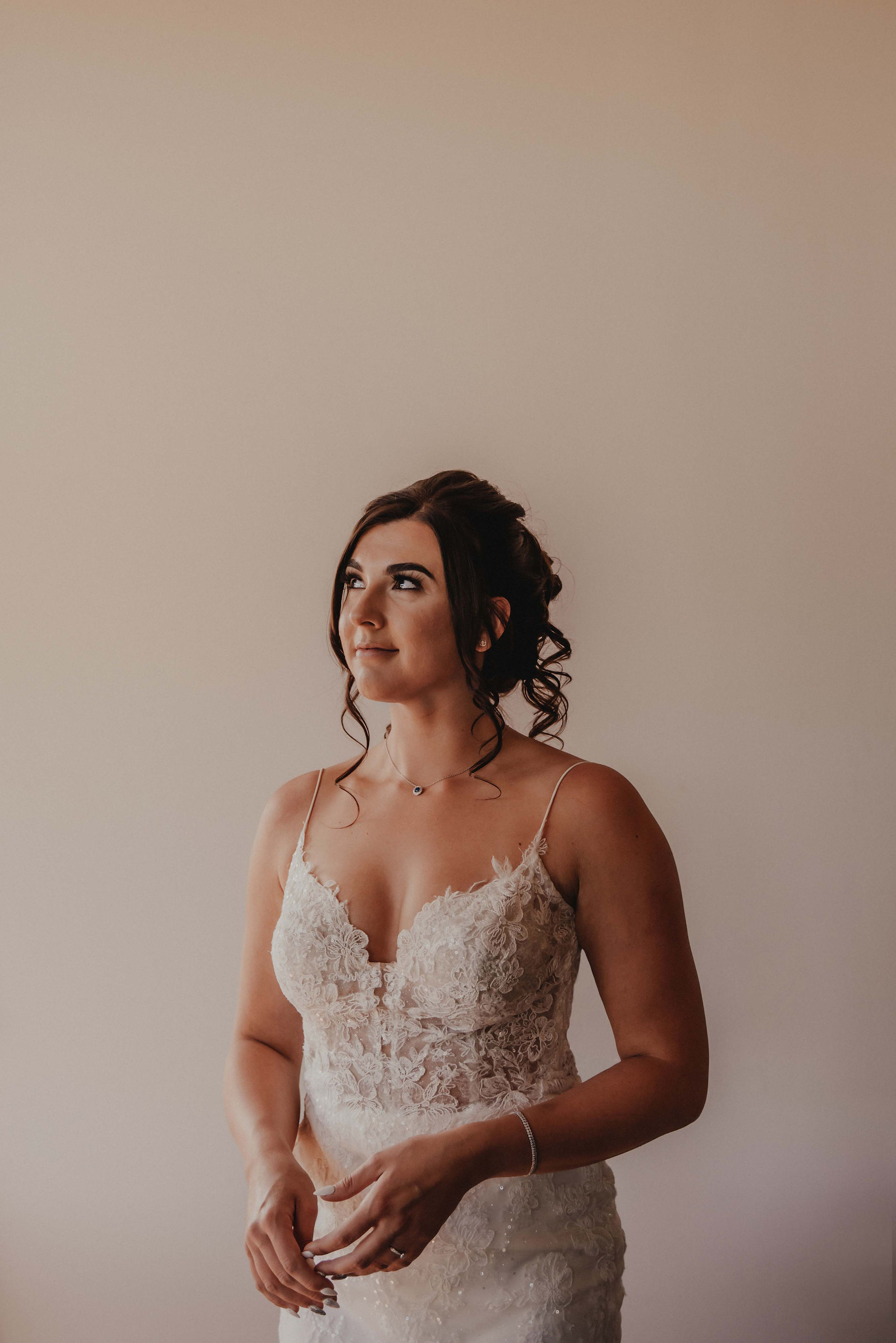 a bride shows off her wedding make up in the natural light