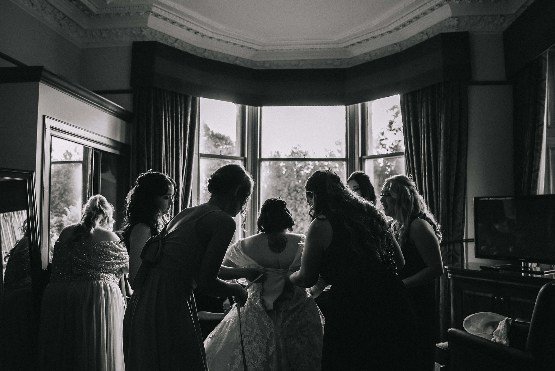 A Scottish bride is helped by her bridesmaids on the morning of her wedding