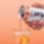 Hand pours peach sparkling drink from a Huel can into a glass with ice and peach slice on a peach background.
