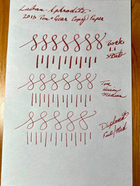 Pink Brown ink writing on white paper reads "Laban Ink Made in Taiwan Aphrodite Pink," with looping patterns underneath. For the Fountain Pen Ink Review. Aphrodite by Laban