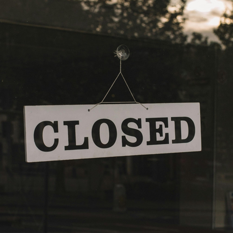 Closed sign hanging on window
