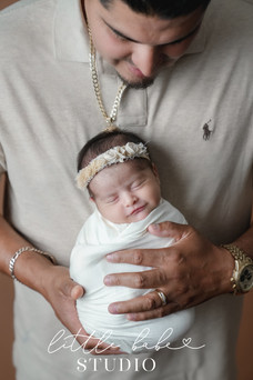 Close up of newborn girl with dad during family session with mom, dad, and baby taken in Middletown, Ohio at Little Babe Studio