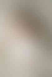 Newborn girl during photoshoot on white flokati with white wrap taken in Middletown, Ohio at Little Babe Studio