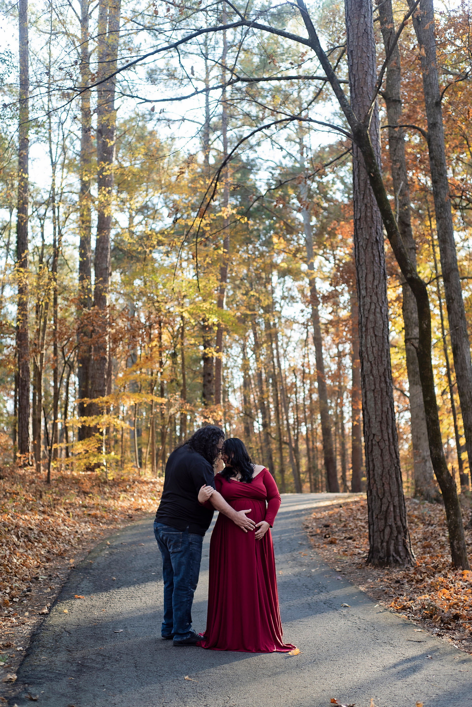 Mom cradling bump in soft light by Greenville Maternity Photographer