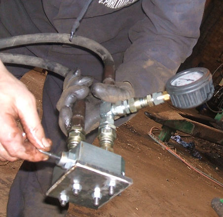 setting muck spreader bed drive relief valve pressure