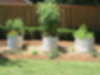 3 white stock tank planters with flowers