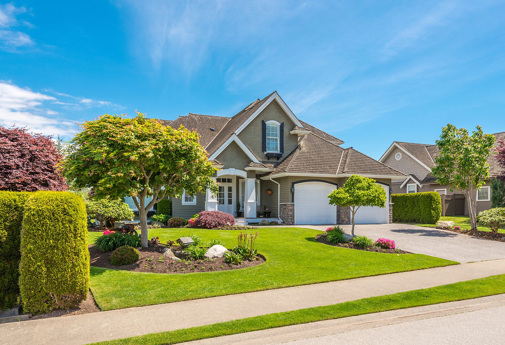 Gorgeous house with stunning front lawn landscaping.