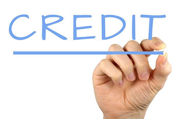 Credit card mistakes- Hand holding a blue marker, underlining the word "CREDIT" on a white background.