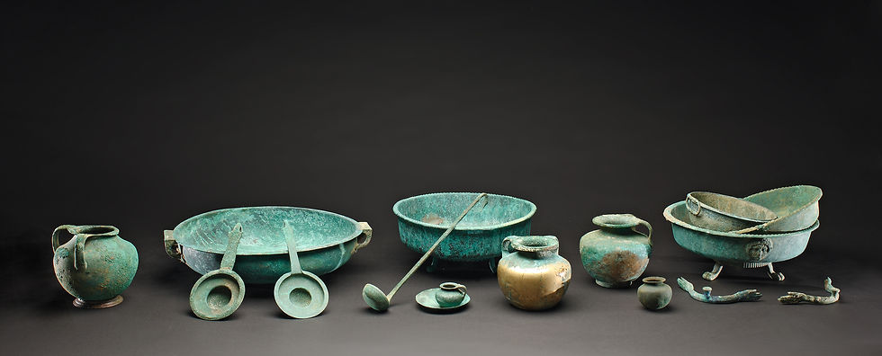 Ensemble of Etruscan or Western Greek bronze vessels, 5th century BC, used at symposia and in daily life, including two-handled oinochoes, tripod basins, wine sieves, a ladle, a small jug and a phiale.