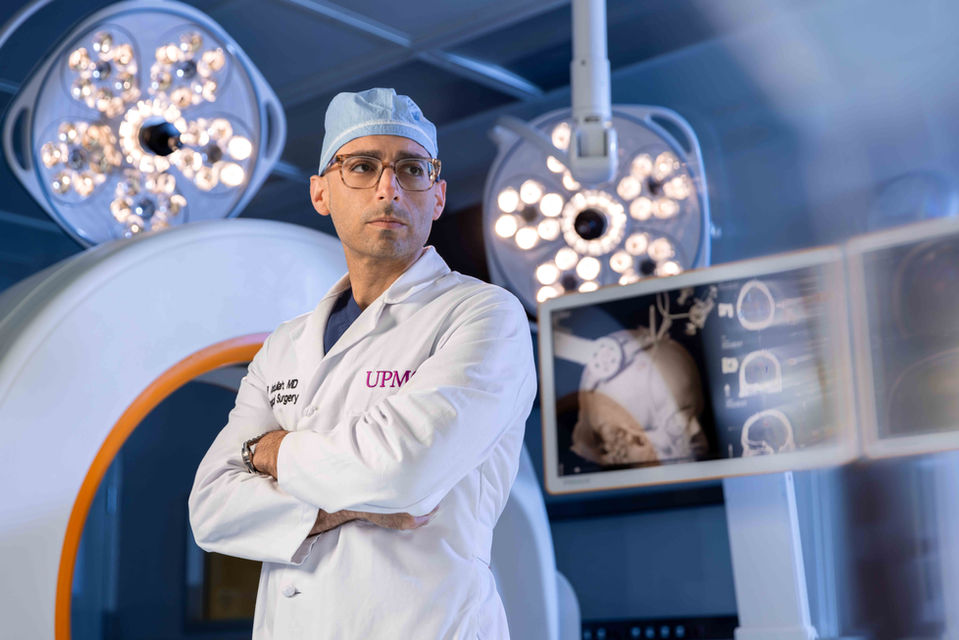 Surgeon portrait in operating room with surgical lights, professional healthcare photography in Pittsburgh
