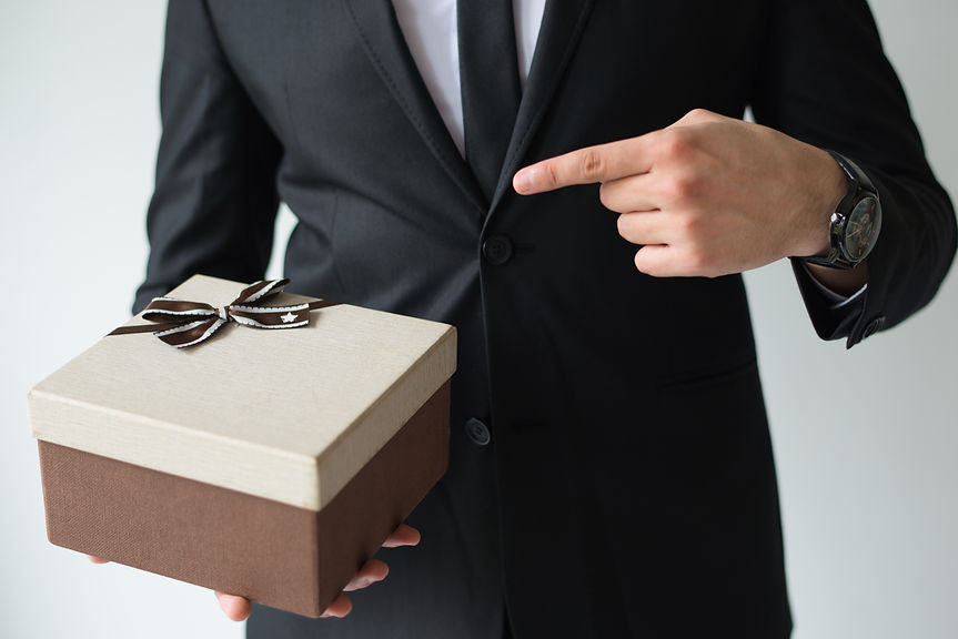 unrecognizable-businessman-holding-brown-gift-box.jpg