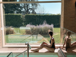 woman sitting beside to a insede pool at Palazzo Fiuggi