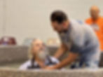 Man being baptized in a pool by another man.