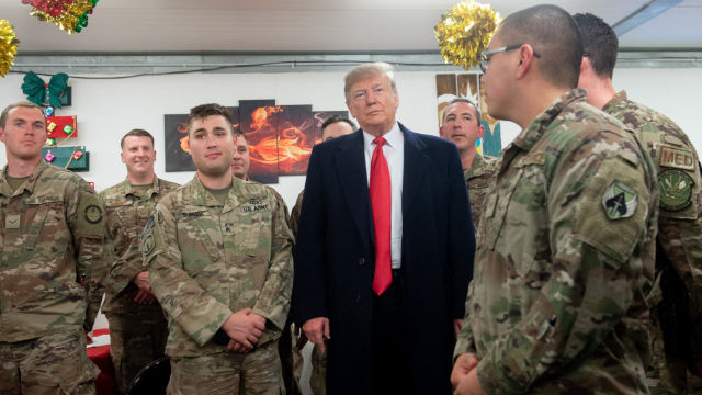 US President Donald Trump greets members of the US military during an unannounced trip to Al Asad Air Base in Iraq on Dec. 26, 2018.