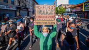 What would efforts to defund or disband police departments really mean?