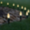 Warm white C9 Christmas lights lining a curved driveway