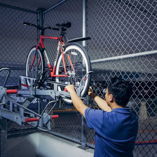 A man is pulling a bicycle rack down