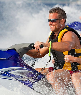 man and woman riding a jetski