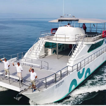 Big catamaran with five crew members on baord