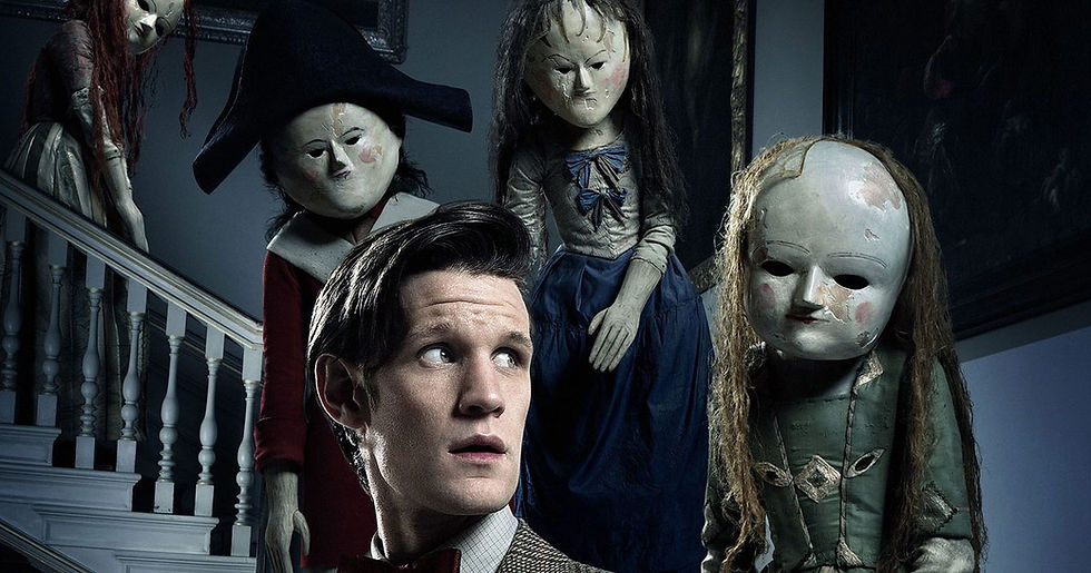 The Doctor looking nervous with creepy dolls descending stairs behind him