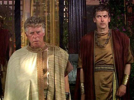 Is that the Twelfth Doctor in a robe dressed a bit like a Roman? Yes, it is. Caecilius stood behind Lucius