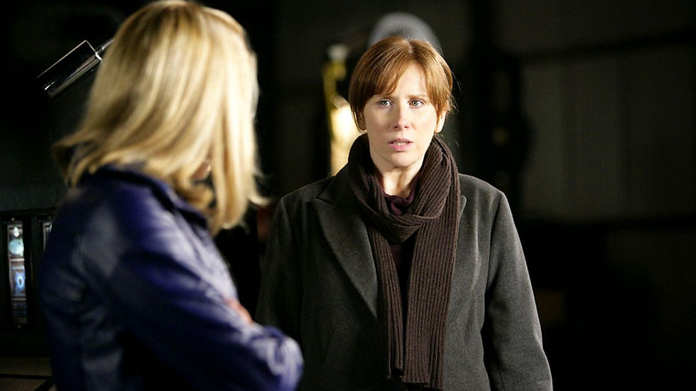 Donna looks at Rose. Donna looks worried, Rose has back to camera