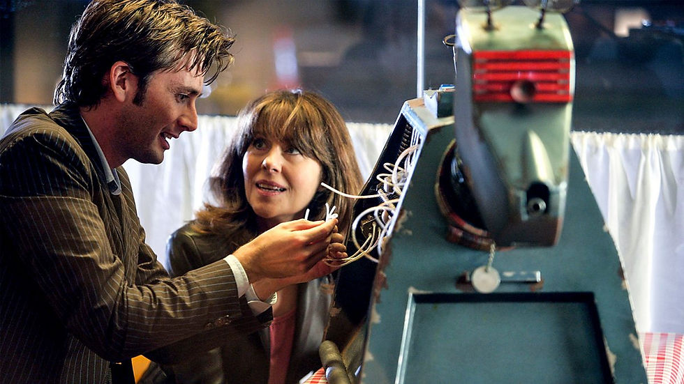 The Doctor fixing K9 as he talks to Sarah Jane