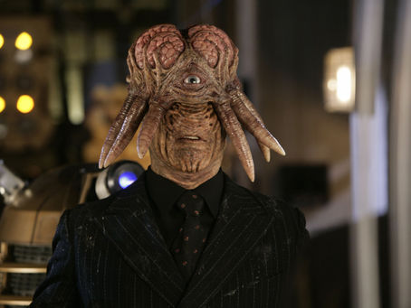 A human Dalek. Tentacles sprouting from head with brain showing, one eye and no nose