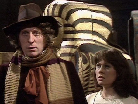 Fourth Doctor and Sarah Jane stood in front of a mummy tomb from Pyramids of Mars
