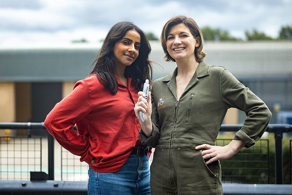 Mandip and Jodie posing for Big Finish photo, both in normal clothes, Jodie holding sonic screwdriver