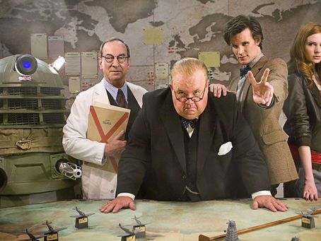 The annoying twat Bracewell in lab coat, a Dalek in army gear, Winston Churchill, the Doctor making a V for victory sign with his fingers and Amy, sat around a planning table in the war rooms