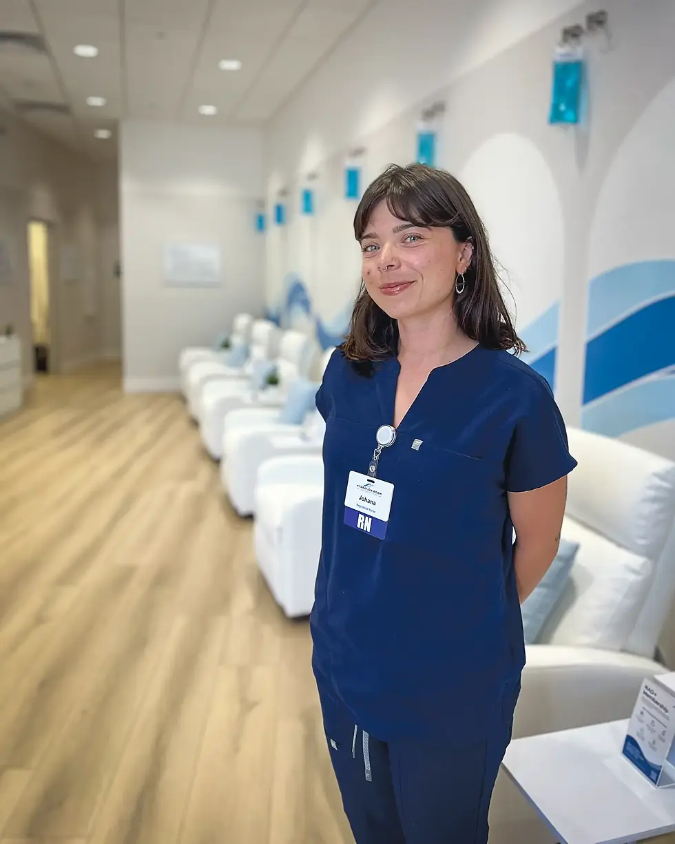 Registered nurse Johana De Brauwere staffs Hydration Room’s new Strawberry Village clinic, where a row of recliners sits beneath wall-mounted IV bags. (Tyler Callister / The Ark)