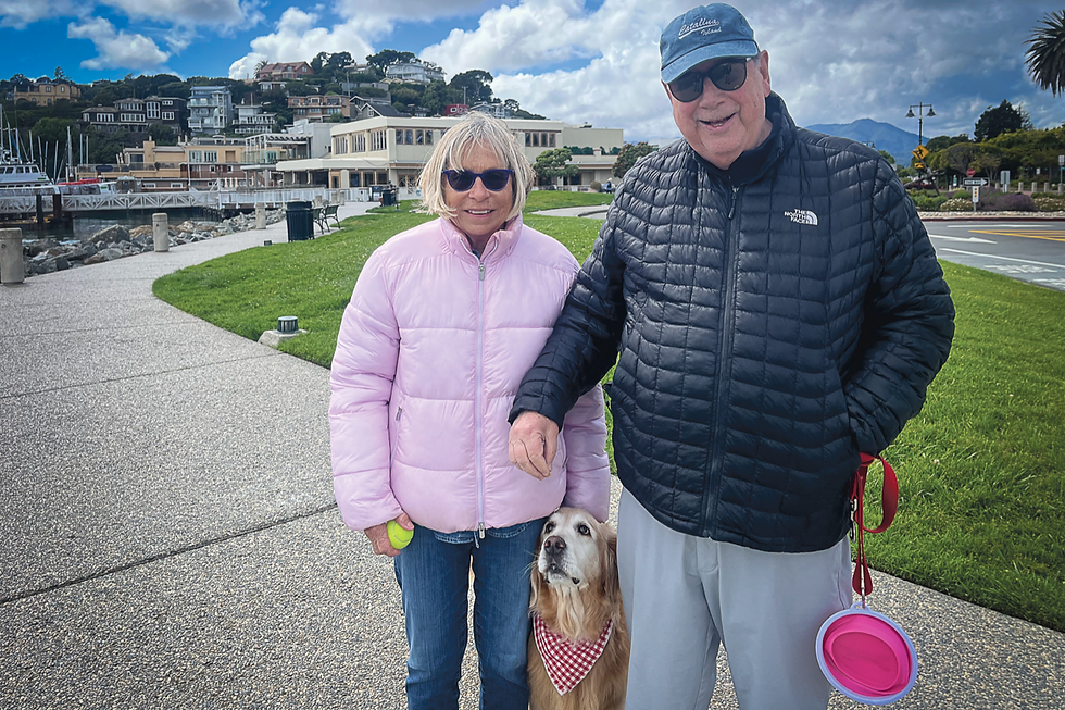 Nancy Floyd and Will Glasgow walk their dog, Brandy, in Shoreline Park in Tiburon on April 21. The couple, who moved to Tiburon in 2019, say Brandy — a trained guide-dog dropout whose friendly nature made her better suited to family life — has become a familiar face in downtown Tiburon. (Tyler Callister / The Ark)
