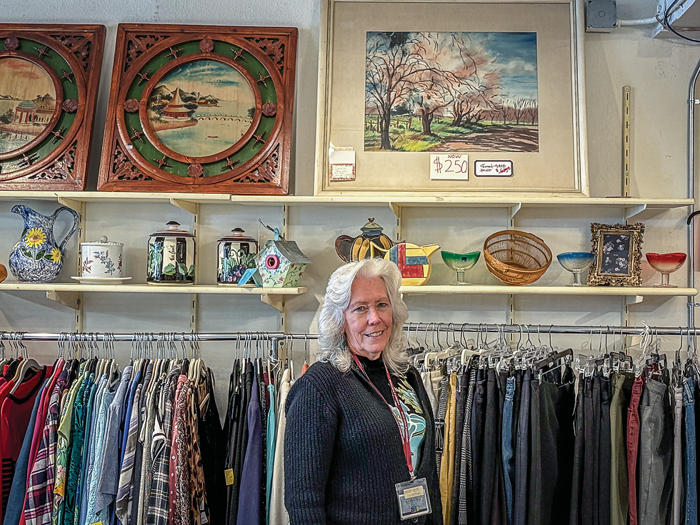 Nancy Sumner stands in front of clothing, antique items and paintings during her monthly shift at the Tiburon Thrift Shop & Boutique on lower Ark Row. (Naomi Friedland / The Ark)