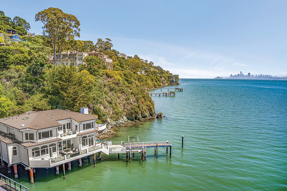 The $17.9 million Belvedere estate at 97 West Shore Road features two boat lifts and panoramic views of San Francisco Bay, with the San Francisco skyline visible in the distance. (via Smith + Aylwin Team)