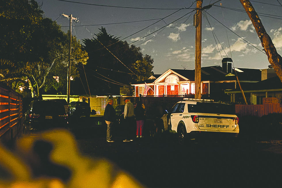 A Marin County Sheriff’s Office patrol vehicle and people standing on Strawberry Circle at night