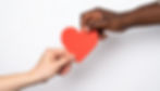 Firefly multi cultural hand giving another hand a red paper heart with a white background