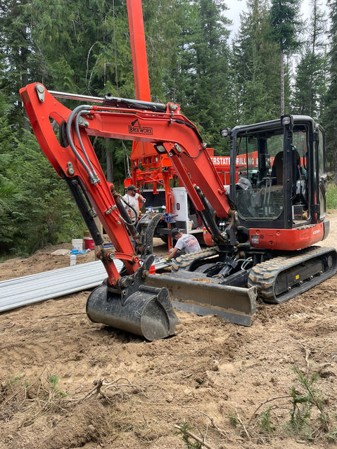 Put in a temporary road and level sight for a water well drilling rig.