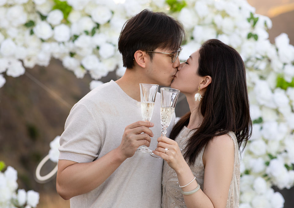 Newly engaged couple celebrating with champagne after a proposal in Madeira