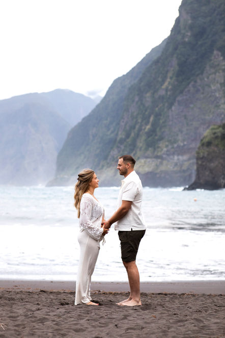Pregnant woman in elegant dress during golden sunset on Madeira Island